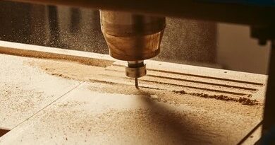 wood router cutting groove into wooden surface with spinning bit