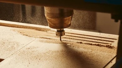 wood router cutting groove into wooden surface with spinning bit