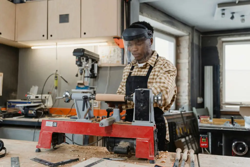 a man working with a lathe machine