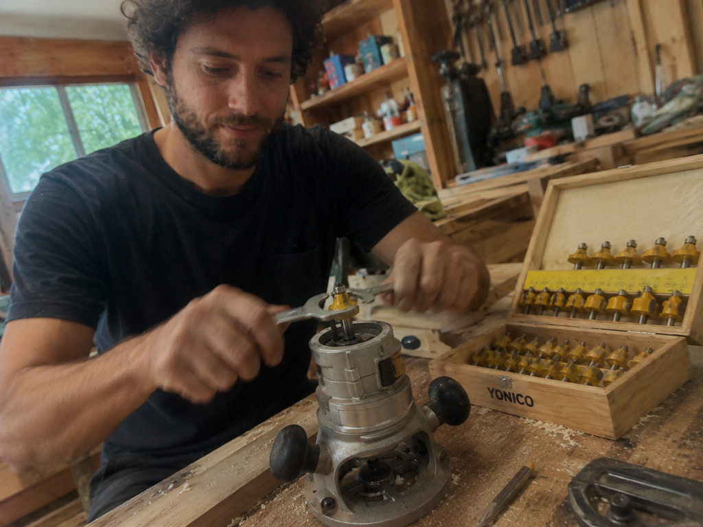 jake installing a yellow yonico router bit into a compact router using two wrenches
