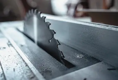  close up of a table saw blade installed in a metal table surface
