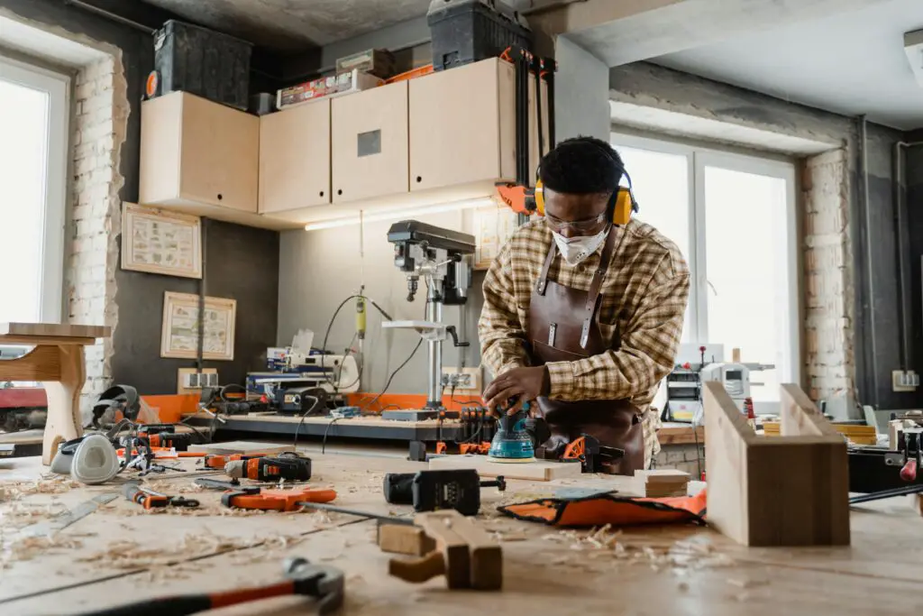 a man working with a wood router machine