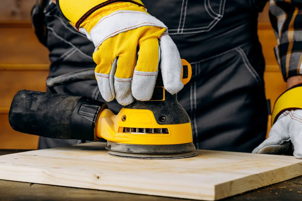 man working with an orbital sander