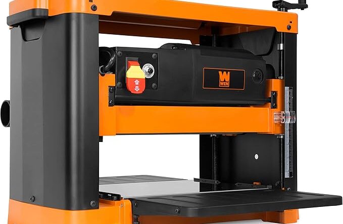 a 13-inch benchtop wen planer featuring an orange and black housing with a precision thickness adjustment crank