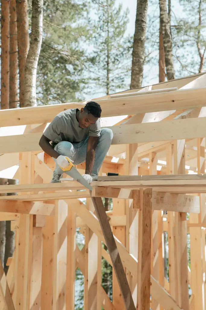 man cutting wood with handsaw tool