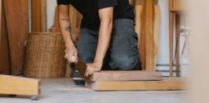 a man working with a hand planer