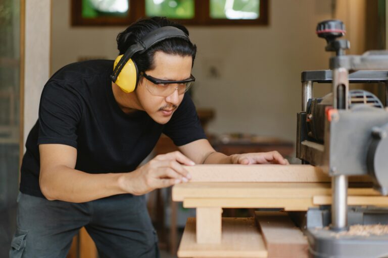 a man working with a hercules planer machine for a wood working project