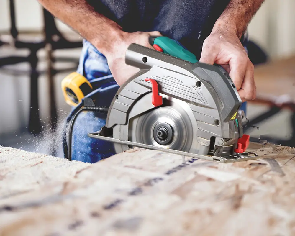 a man working with a ryobi saw