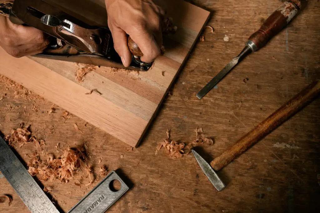 a man working with an ace wood planer