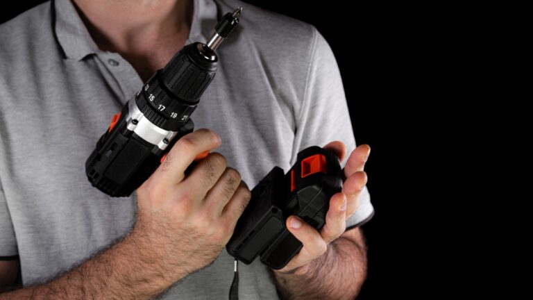 man changing cordless drill battery.jpg